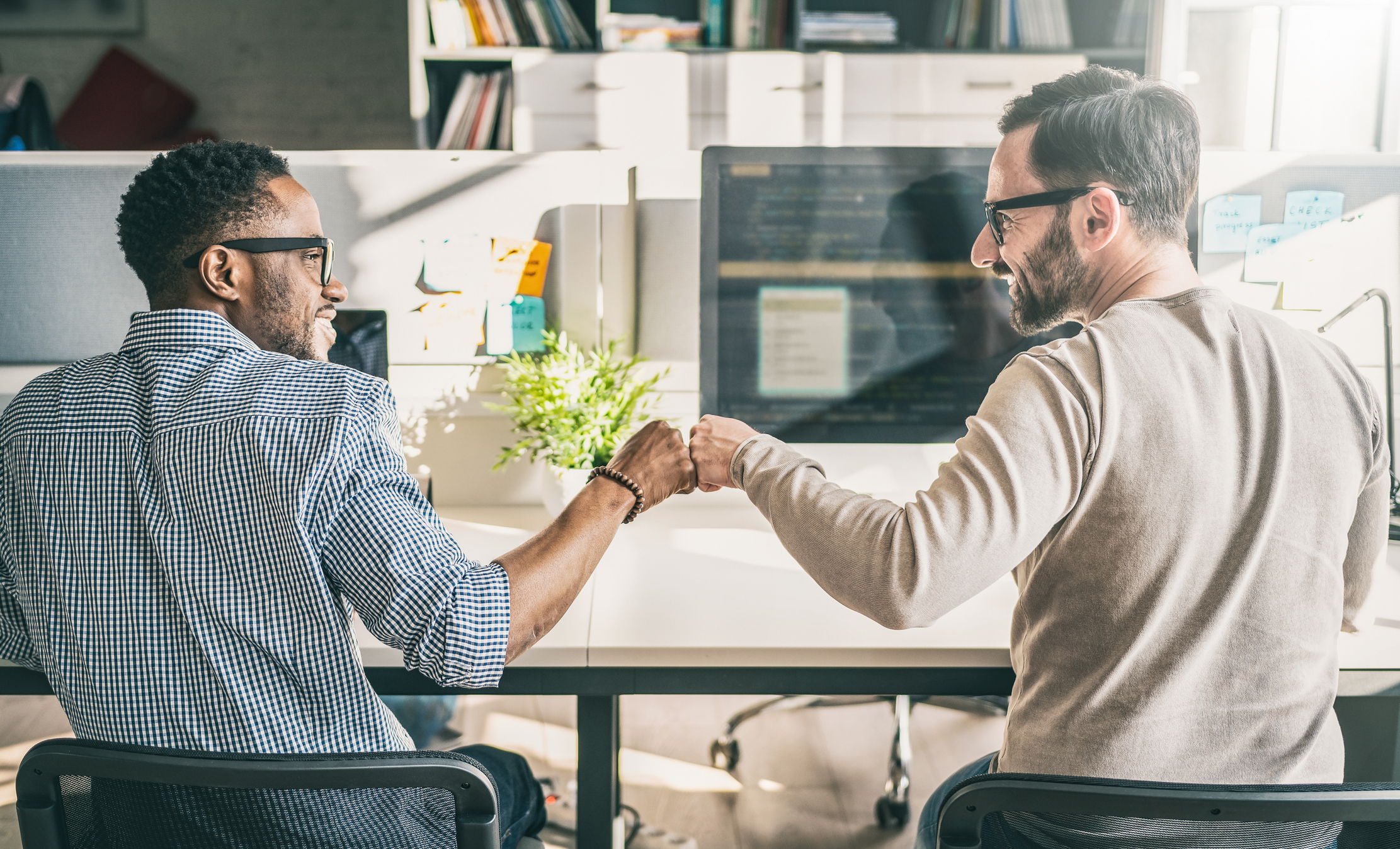 Two business partners reviewing operating agreement terms